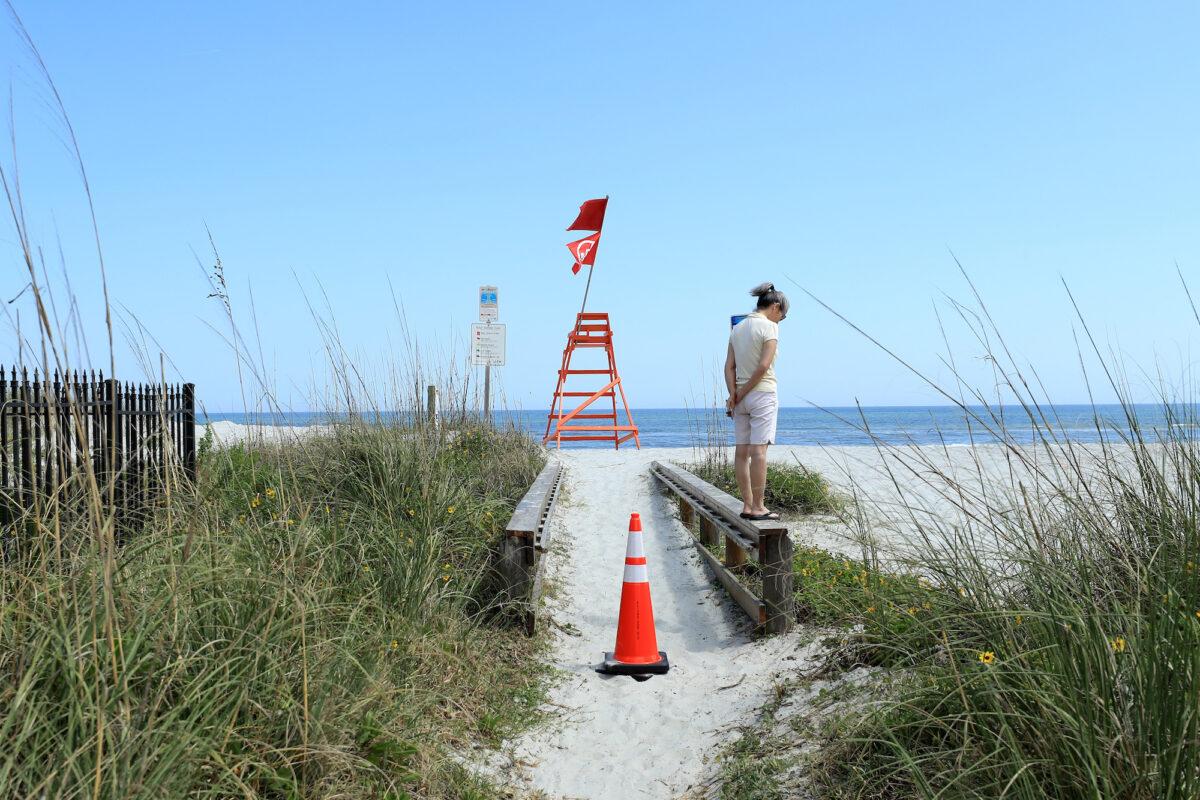 A person looks out toward Jacksonville Beach, Florida, on March 21, 2020. (Sam Greenwood/Getty Images)