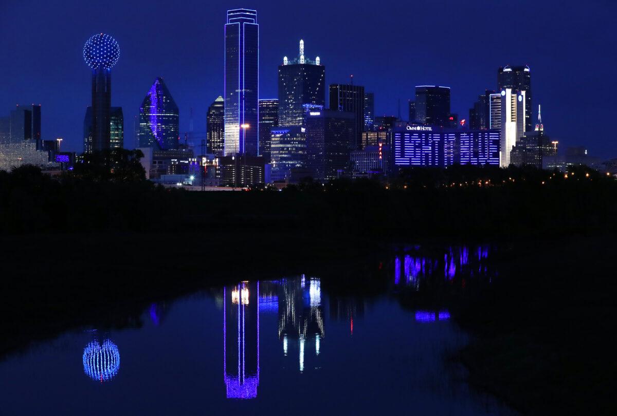 The Omni Dallas Hotel carries the message "Light It Blue" across the skyline on April 9, 2020 in Dallas Texas. Landmarks and buildings across the nation are displaying blue lights to show support for health care workers and first responders on the front lines of the COVID-19 pandemic. (Tom Pennington/Getty Images)