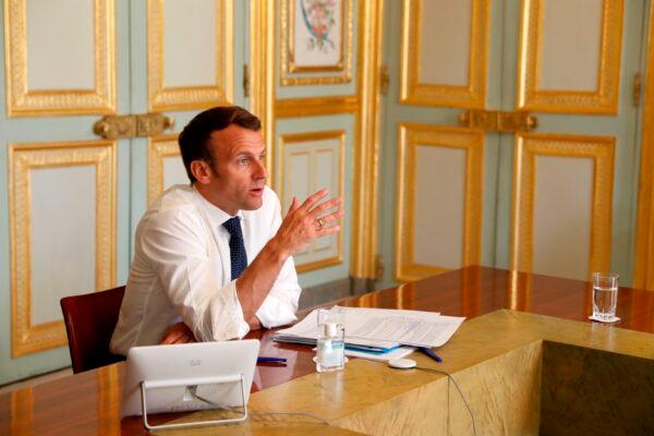 French President Emmanuel Macron, attends a video conference call with French virologist and President of the Research and Expertise Analysis Committee (Comite Analyse Recherche et Expertise, CARE) Francoise Barre-Sinoussi on ongoing efforts to accelerate the development and access to vaccine and treatment against the CCP virus at the Elysee Palace in Paris, on April 16, 2020. (Yoan Valat/Pool Photo via AP)