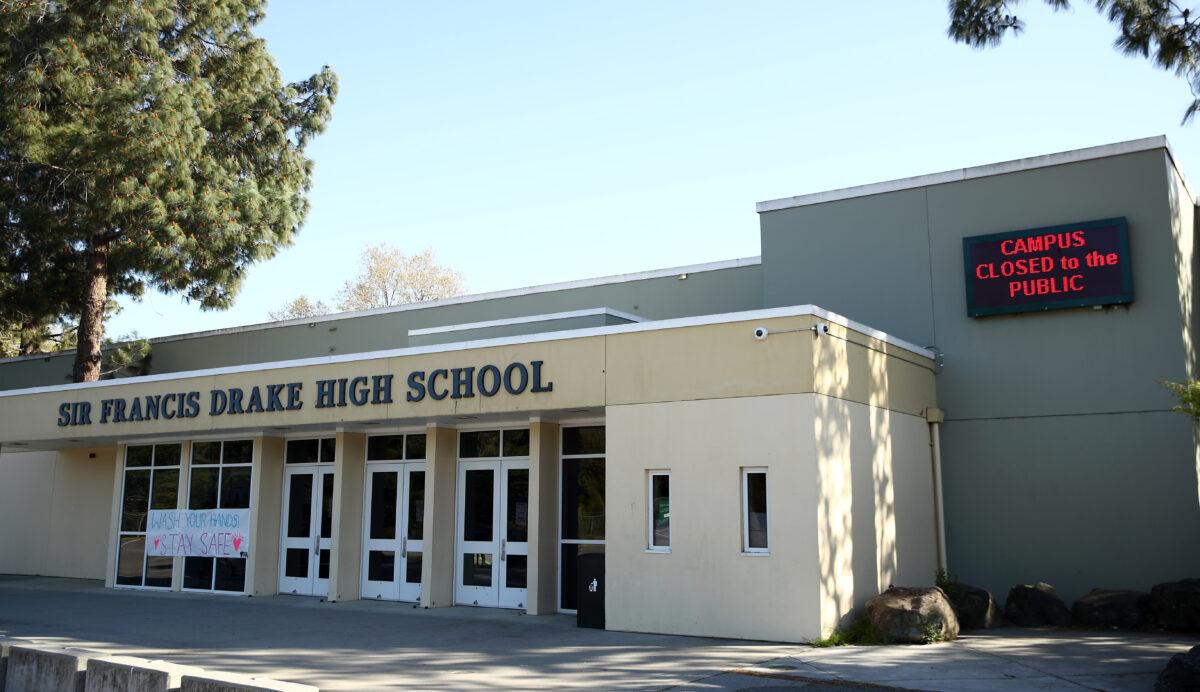 Signs outside Sir Francis Drake High School in San Anselmo, Calif., show that the school is closed because of COVID-19 on March 31, 2020. (Ezra Shaw/Getty Images)