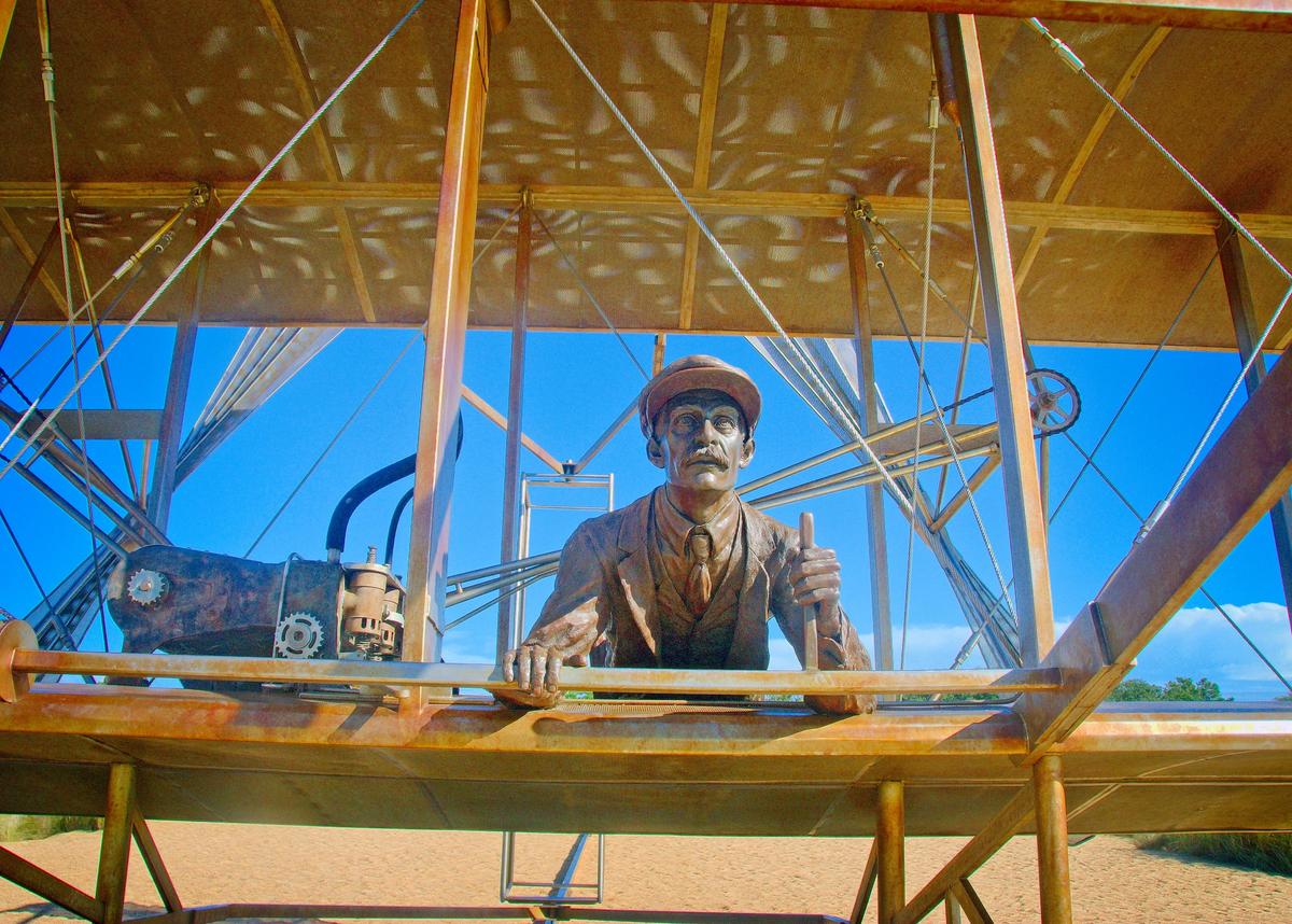 This sculpture at the Wright Brothers National Memorial depicts Orville Wright at the controls of the machine he and his brother Wilbur built as it lifts off the ground on Dec. 17, 1903. (Copyright Fred J. Eckert)
