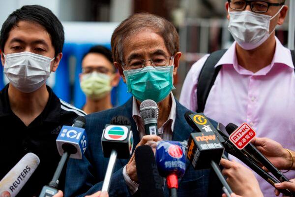 Former lawmaker and pro-democracy activist Martin Lee (C) talks to members of the media as he leaves the Central District police station in Hong Kong on April 18, 2020, after being arrested and accused of organizing and taking part in an unlawful assembly in August last year. (Photo by Isaac Lawrence/AFP via Getty Images)