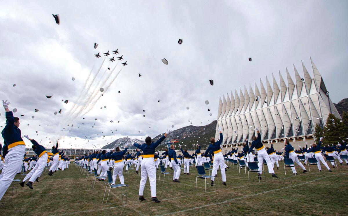 The class of 2020 tossed their caps in the air as the Thunderbirds flew over at the conclusion of the U.S. Air Force Academy graduation in Colorado Springs, Colo., on April 18, 2020. (Christian Murdock/The Gazette via AP)