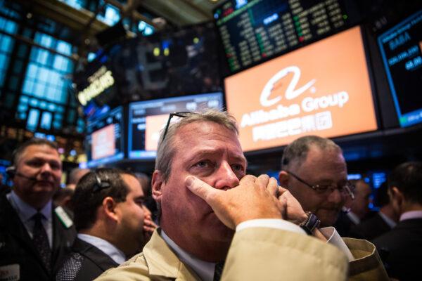 Traders work on the floor of the New York Stock Exchange while the price of Alibaba Group's initial price offering (IPO) is decided, in New York City on Sept. 19, 2014. (Andrew Burton/Getty Images)