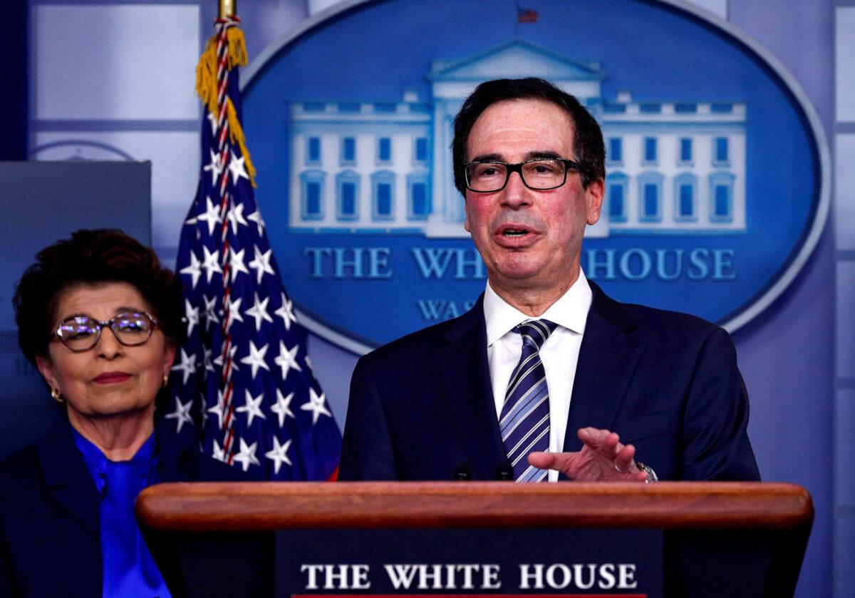 Treasury Secretary Steven Mnuchin discusses details for economic relief during the daily CCP virus response briefing as Small Business (SBA) Administrator Jovita Carranza listens at the White House in Washington, on April 2, 2020. (Tom Brenner/Reuters)
