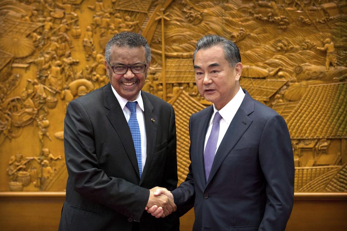 Tedros Adhanom Ghebreyesus, Director-General of the WHO, shakes hands with Chinese Foreign Minister Wang Yi in Beijing, on July 17, 2018. (AP Photo/Mark Schiefelbein, Pool)