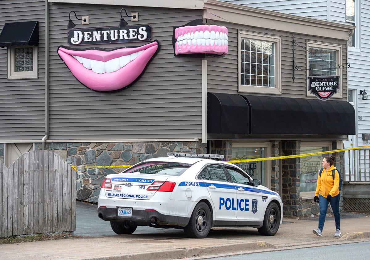 The Atlantic Denture Clinic is guarded by police in Dartmouth, Nova Scotia, Canada, on April 20, 2020. (Andrew Vaughan/The Canadian Press)