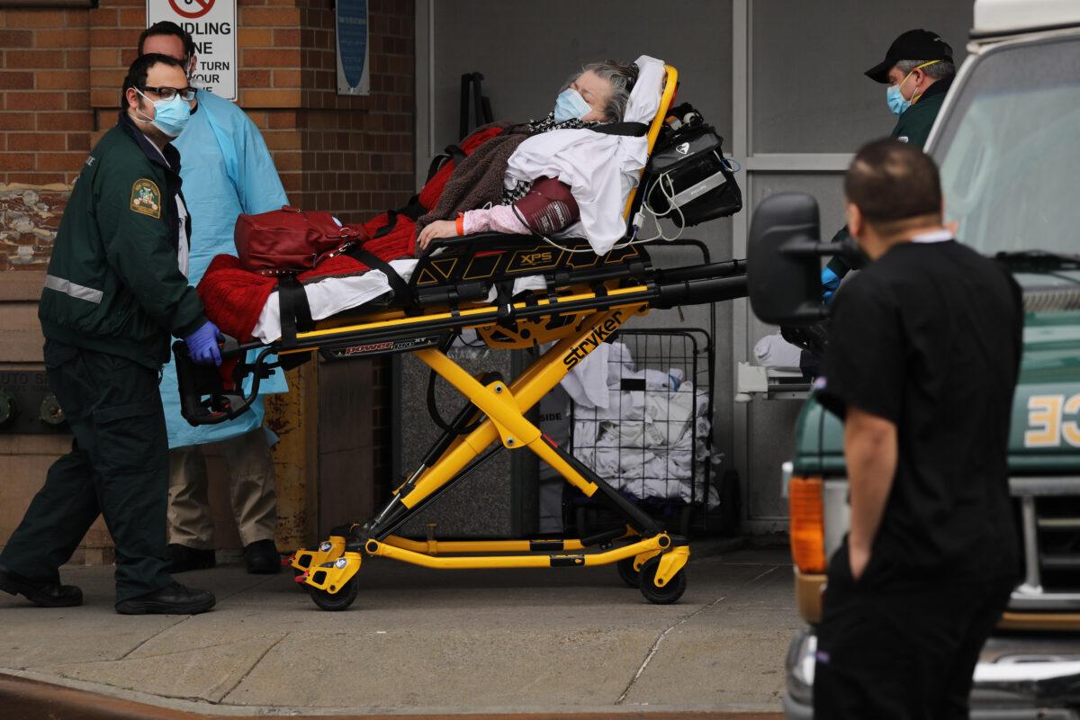 Medical workers transport a patient outside of a special CCP virus intake area at Maimonides Medical Center in Brooklyn, New York City, on April 20, 2020. (Spencer Platt/Getty Images)
