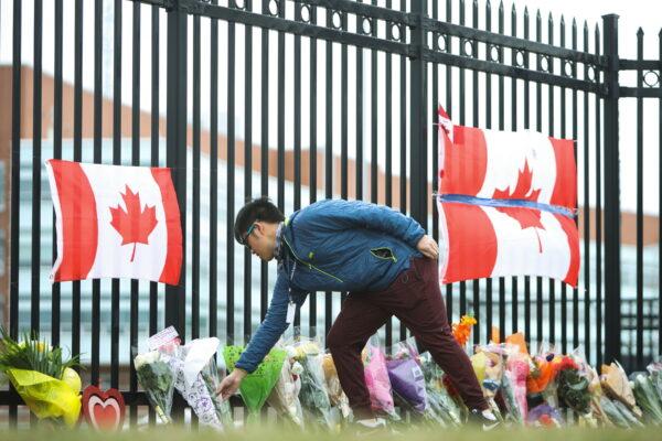 A person leaves flowers at a make-shift memorial dedicated to Constable Heidi Stevenson at RCMP headquarters in Dartmouth, Nova Scotia, on April 20, 2020. (The Canadian Press/Riley Smith)