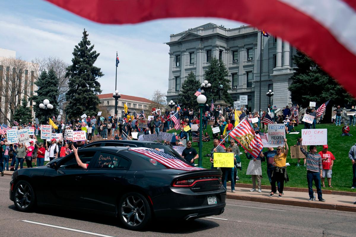 Demonstrators gather in front of the Colorado State Capitol building during a "ReOpen Colorado" rally in Denver, Colorado, on April 19, 2020. (JASON CONNOLLY/AFP via Getty Images)