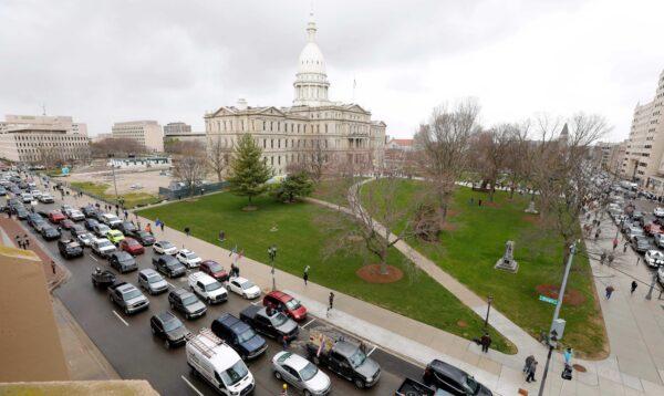 People in their vehicles protest against excessive quarantine orders from Michigan Gov. Gretchen Whitmer around the Michigan State Capitol in Lansing, Mich., on April 15, 2020. (Jeff Kowalsky/AFP via Getty Images)