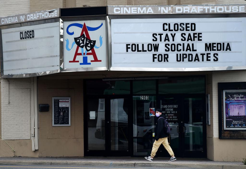 A man walks past a closed theater in Arlington, Va., on April 18, 2020. (Olivier Douliery/AFP via Getty Images)