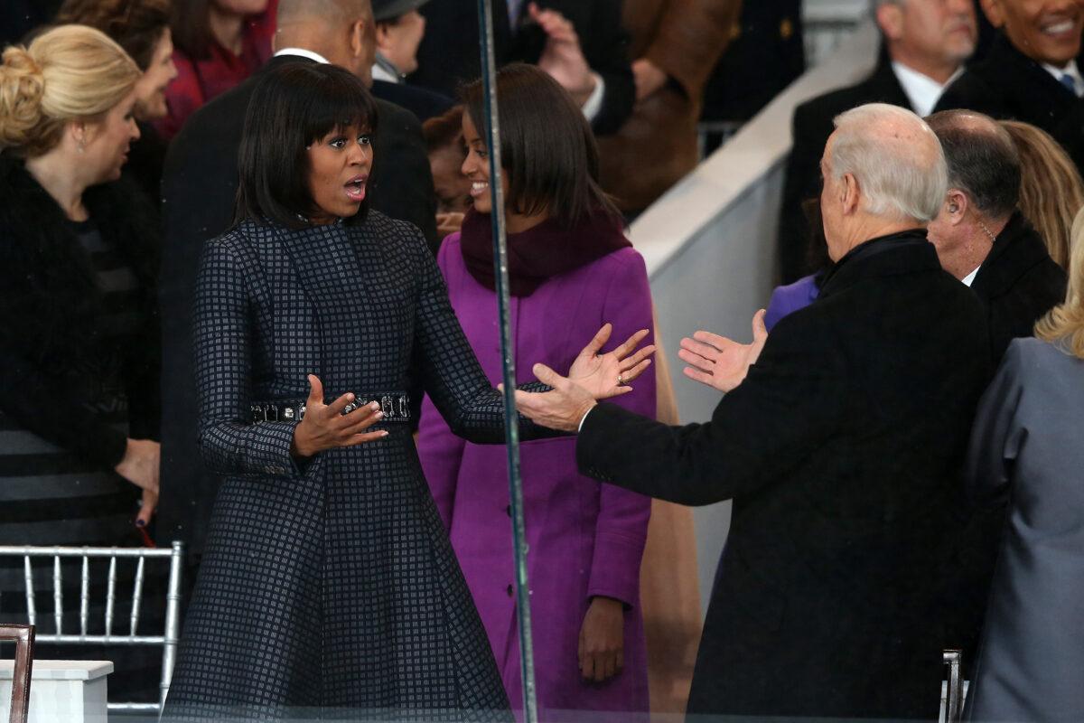 First lady Michelle Obama (L) greets Vice President Joe Biden on the reviewing stand as the presidential inaugural parade winds through the nation's capital in Washington on Jan. 21, 2013. (Mark Wilson/Getty Images)