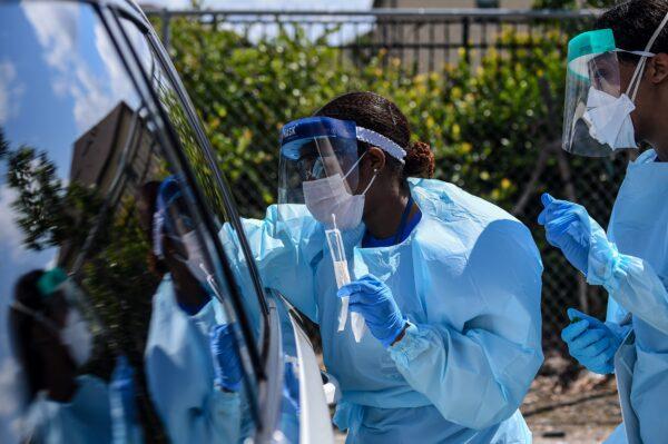 Medical personnels take medical samples of patients at a "drive-thru" CCP virus testing lab set up by local community centre in West Palm Beach 75 miles north of Miami, on March 16, 2020. (Chandan Khanna/AFP via Getty Images)