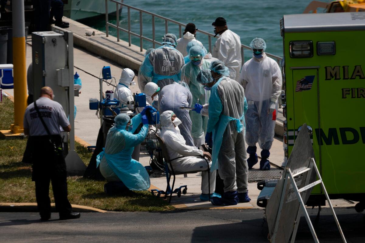 Medical staff attend to suspected CCP virus patients as they arrive from cruise ships at U.S. Coast Guard Base Miami Beach in Miami, Florida on March 26, 2020. (Eva Marie Uzcategui/Getty Images)