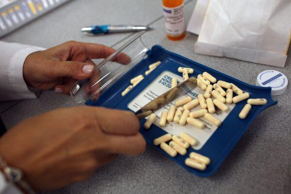 A pharmacist counted out the correct number of antibiotic pills to fill a prescription in Miami, Fla., on Aug. 7, 2007. (Joe Raedle/Getty Images)