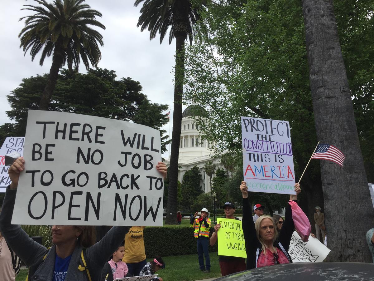 Hundreds of people gather around the California State Capitol to protest against the statewide lockdown in Sacramento on April 20, 2020. (Laurie Gorham/The Epoch Times)