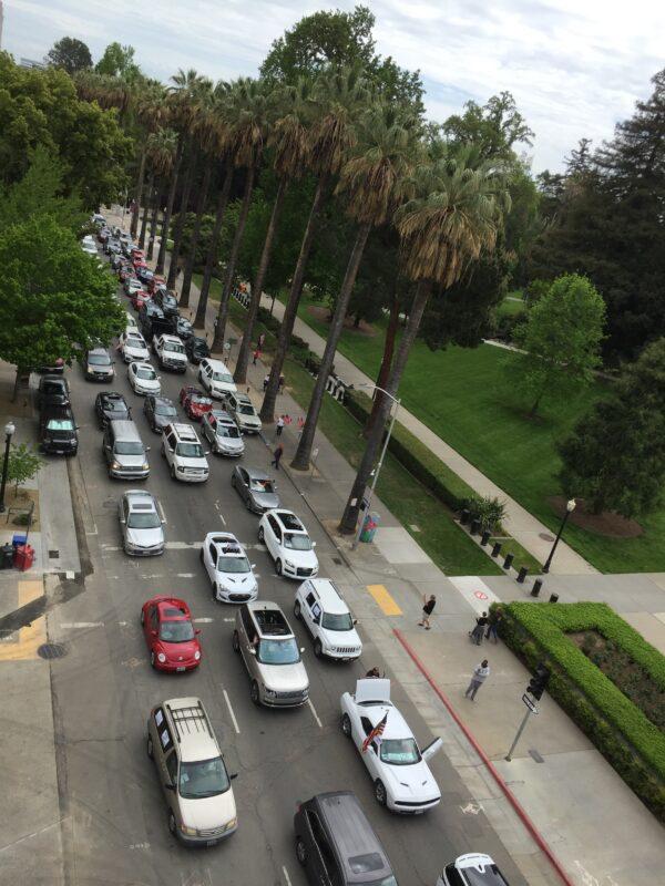 Vehicles circle around the California State Capitol in Sacramento on April 20, 2020, to protest against the statewide lockdown. (Laurie Gorham/The Epoch Times)