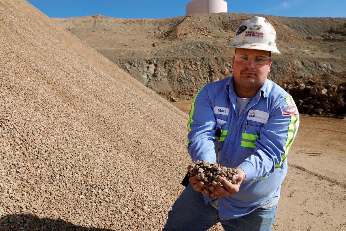 Matt Green, mining/crushing supervisor at MP Materials, displays crushed ore before it is sent to the mill at the MP Materials rare earth mine in Mountain Pass, Calif., on Jan. 30, 2020. (Steve Marcus/Reuters)