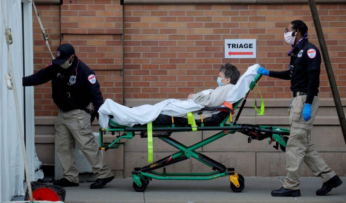 Paramedics take a patient into the emergency center at Maimonides Medical Center during the outbreak of the CCP virus in the Brooklyn borough of New York, on April 14, 2020. (Brendan McDermid/Reuters)