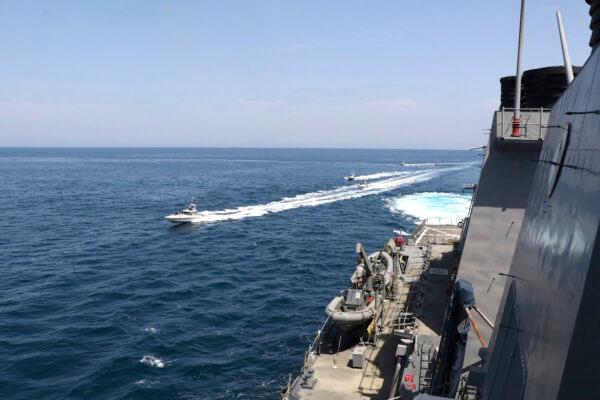 Iranian Revolutionary Guard vessels sail close to U.S. military ships in the Persian Gulf near Kuwait on April 15, 2020. (U.S. Navy via AP)