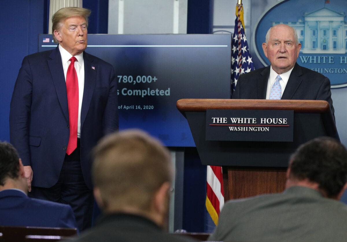 Secretary of Agriculture Sonny Perdue speaks while flanked by President Donald Trump during the daily briefing of the White House Coronavirus Task Force in Washington on April 17, 2020. (Alex Wong/Getty Images)