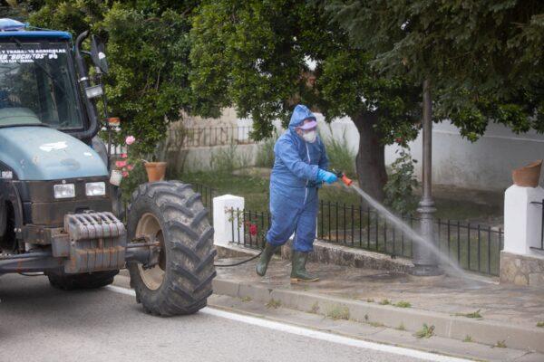 A volunteer disinfects the streets of the town during the CCP virus pandemic in Zahara de la Sierra, Spain, on April 20, 2020. (Juan Carlos Toro/Getty Images)