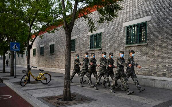 Chinese military march in the street in Beijing, China on April 22, 2020. (Kevin Frayer/Getty Images)