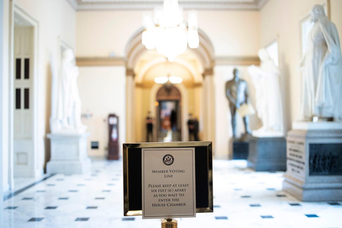 A sign instructing members of the House of Representatives to maintain social distancing requirements while voting is shown at the U.S. Capitol on April 23, 2020, in Washington. (Win McNamee/Getty Images)