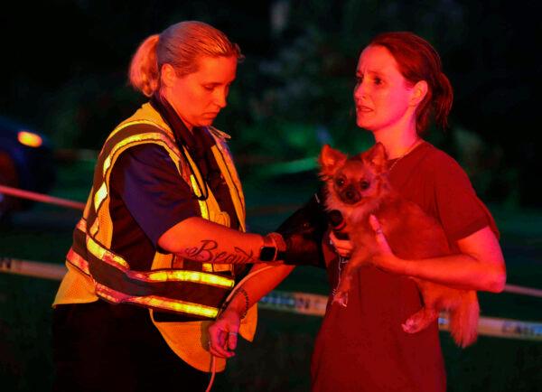 A woman received medical attention after an apparent tornado touched down in Onalaska, Texas, on April 22, 2020. (Jason Fochtman/Houston Chronicle via AP)