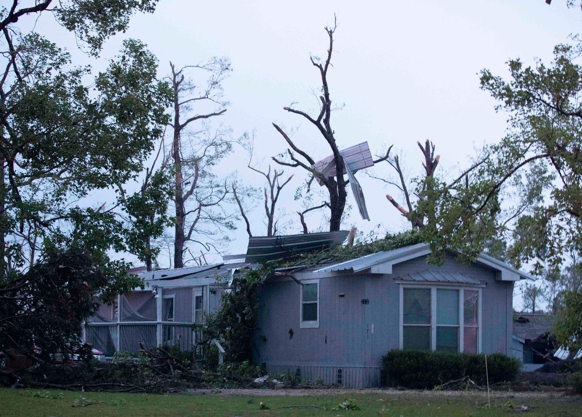 A damaged home is seen after an apparent tornado touched down in Onalaska, Tex., on April 22, 2020, (Jason Fochtman/Houston Chronicle via AP)