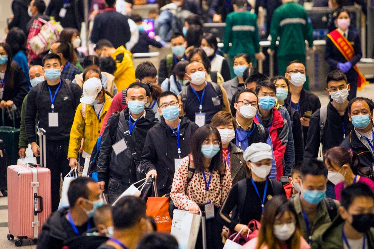 Migrant workers and their relatives are waiting for the train to go to Shenzhen at Yichang East Station in Yichang in China's Hubei Province on March 23, 2020. (STR/AFP via Getty Images)