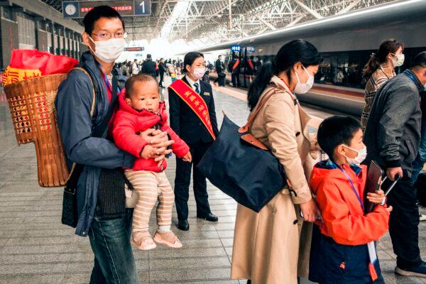 Migrant workers and their relatives are waiting for the train to go to Shenzhen at Yichang East Station in Yichang in China's central Hubei province on March 23, 2020. (STR/AFP via Getty Images)
