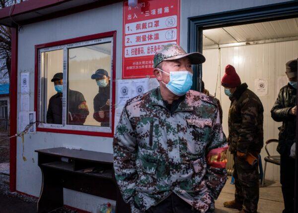 A staff member keeping watch at a checkpoint in the border city of Suifenhe, in China's northeastern Heilongjiang province on April 21, 2020. (STR/AFP via Getty Images)