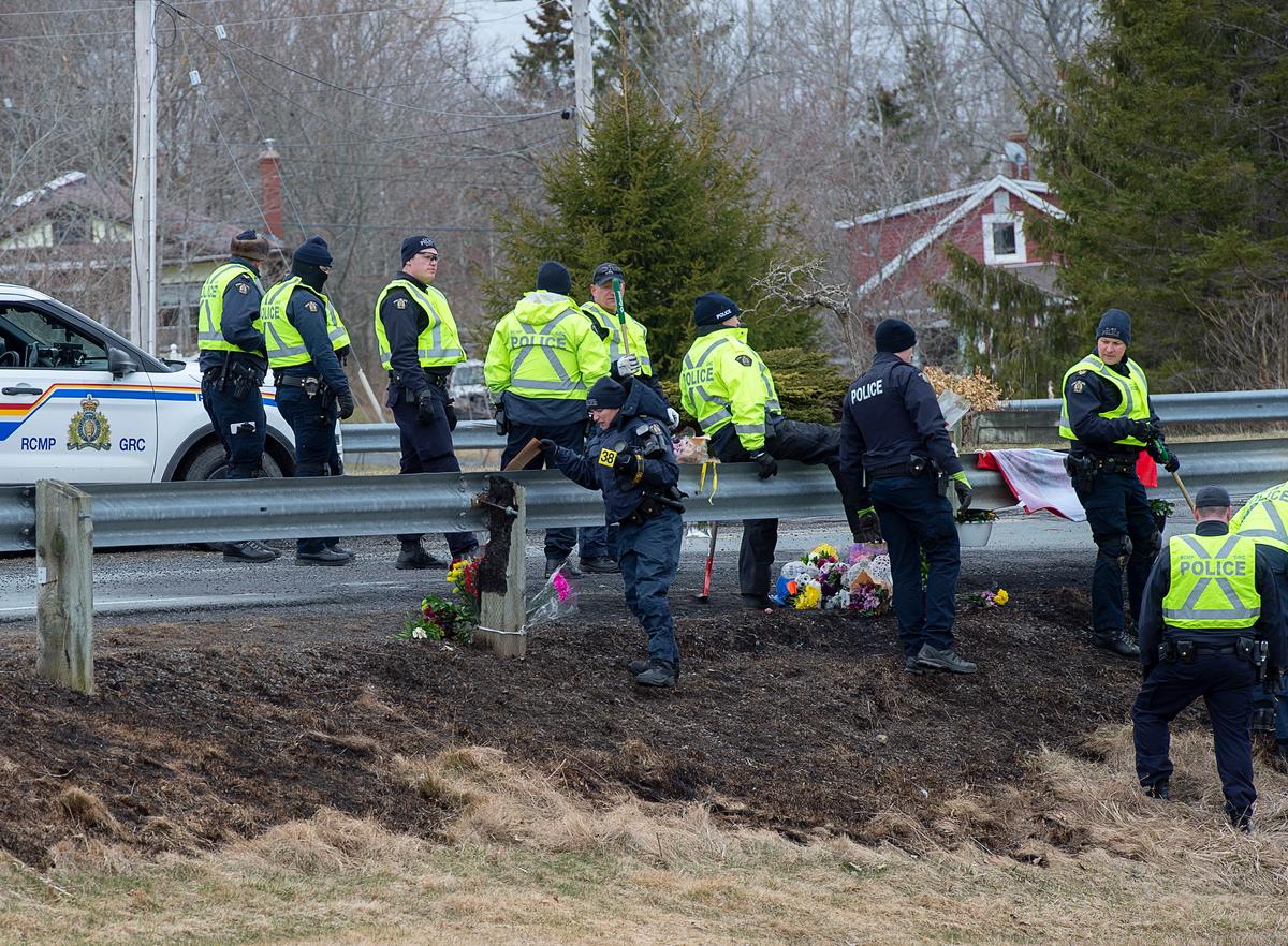 Royal Canadian Mounted Police investigators search for evidence at the location where Constable Heidi Stevenson was killed along the highway in Shubenacadie, Nova Scotia, Canada, on April 23, 2020. (Andrew Vaughan/The Canadian Press via AP)