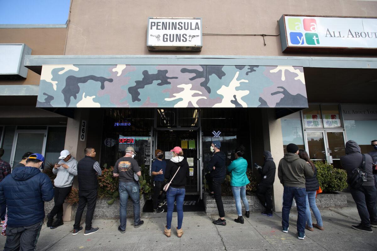People wait in line outside a gun store in San Bruno, California, on March 16, 2020. (Justin Sullivan/Getty Images)