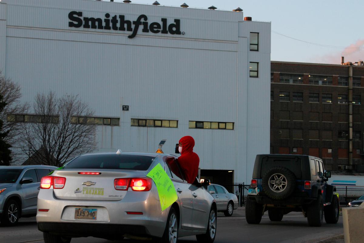 Employees and family members protest outside a Smithfield Foods processing plant in Sioux Falls, South Dakota, on April 9, 2020. (AP Photo/Stephen Groves File)