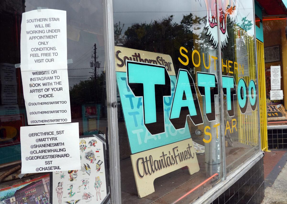 A sign on the window of Southern Star Tattoo informs customers that tattoos are by appointment only in Little Five Points in Atlanta, Georgia, on April 23, 2020. (Tami Chappell/AFP/Getty Images)