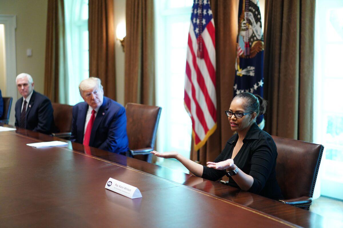 President Donald Trump, Vice President Mike Pence, and members of the Coronavirus Task Force listen to Michigan Rep. Karen Whitsett during a meeting with people who recovered from COVID-19 in Washington on April 14, 2020. (Mandel Ngan/AFP via Getty Images)