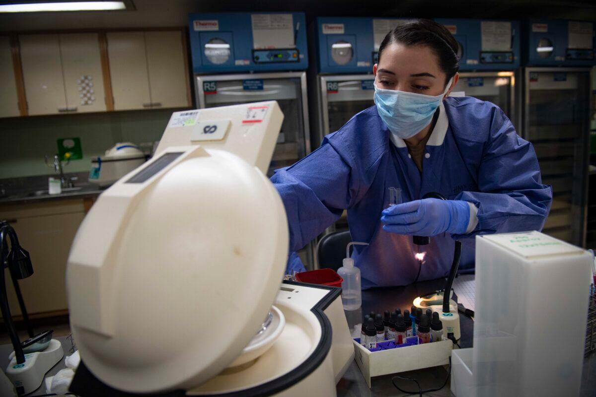Hospital Corpsman 3rd Class Janet Rosas tests blood samples aboard the Military Sealift Command hospital ship USNS Comfort (T-AH 20) while the ship is in New York City to help respond to the COVID-19 pandemic, on April 6, 2020. (Sara Eshleman/US NAVY via Getty Images)