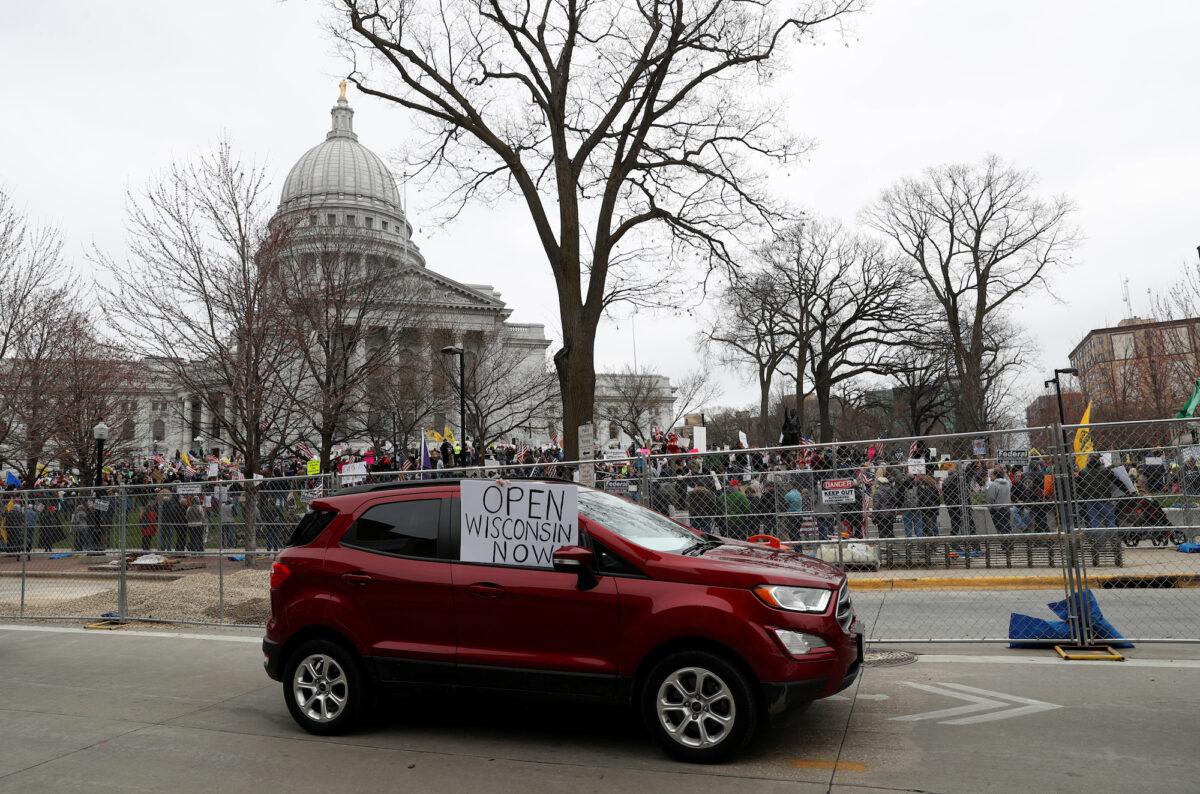A car is seen as demonstrators protest the extension of the emergency Safer at Home order by state Gov. Tony Evers to slow the spread of COVID-19, outside the State Capitol building in Madison, Wisconsin, on April 24, 2020. (Shannon Stapleton/Reuters)