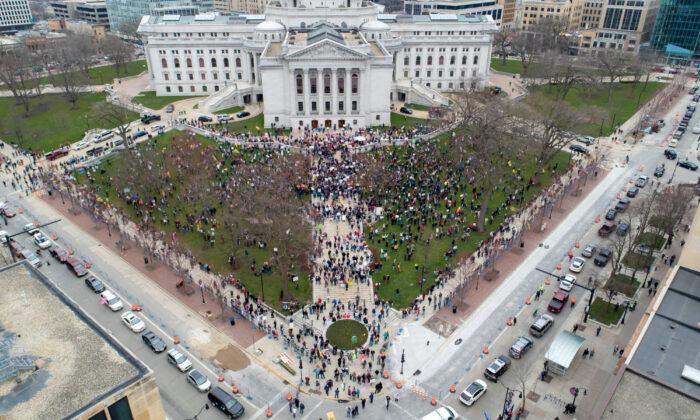 Protesters against the state's extended slow-the-spread stay-at-home order demonstrate at the Capitol building in Madison, Wis., on April 24, 2020. (REUTERS/Daniel Acker)