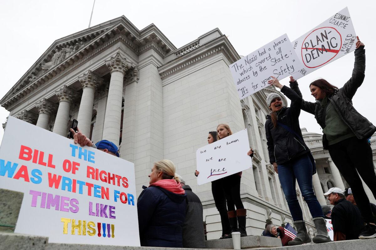 Demonstrators protest the extension of Wisconsin’s stay-at-home order, outside the State Capitol building in Madison, Wisconsin, on April 24, 2020. (Shannon Stapleton/Reuters)