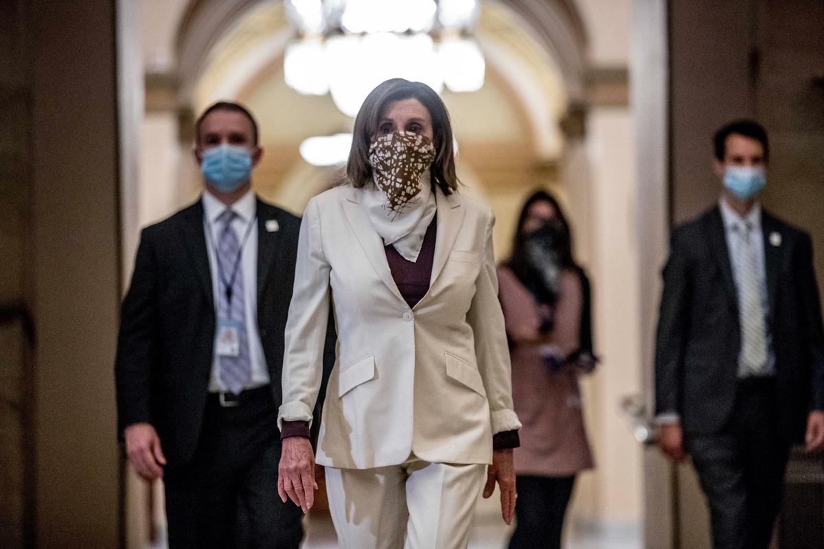 House Speaker Nancy Pelosi (D-Calif.) walks to her office after signing the Paycheck Protection Program and Health Care Enhancement Act, H.R. 266, after it passed the House on Capitol Hill in Washington on April 24, 2020. (Andrew Harnik/AP Photo)