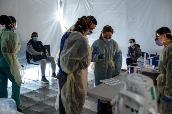 Doctors test hospital staff with flu-like symptoms for coronavirus (COVID-19) in tents set-up to triage possible COVID-19 patients outside before they enter the main Emergency department area at St. Barnabas hospital in the Bronx on March 24, 2020. (Misha Friedman/Getty Images)