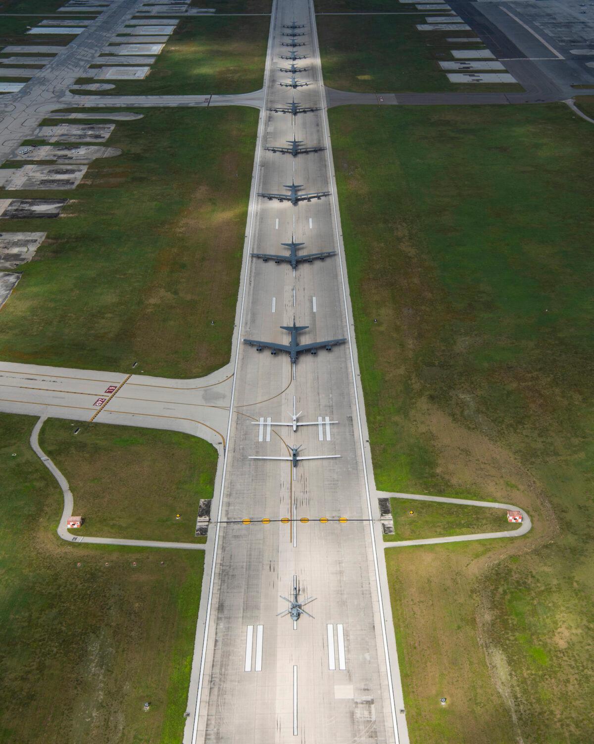 A U.S. Navy MH-60S Knighthawk, U.S. Air Force RQ-4 Global Hawk, Navy MQ-4C Triton, Air Force B-52 Stratofortress’, and KC-135 Stratotankers stationed at Andersen Air Force Base, Guam, perform an "Elephant Walk" April 13, 2020. (U.S. Air Force photo by Senior Airman Michael S. Murphy)