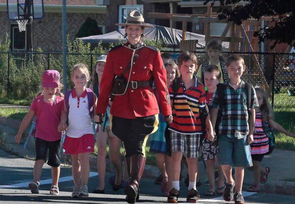 RCMP Const. Heidi Stevenson is shown with children in an undated handout photo. An online campaign is seeking support to change the name of a high school to honour the RCMP officer killed during last week's shooting rampage in Nova Scotia that claimed 22 lives. (Ho/RCMP via The Canadian Press)