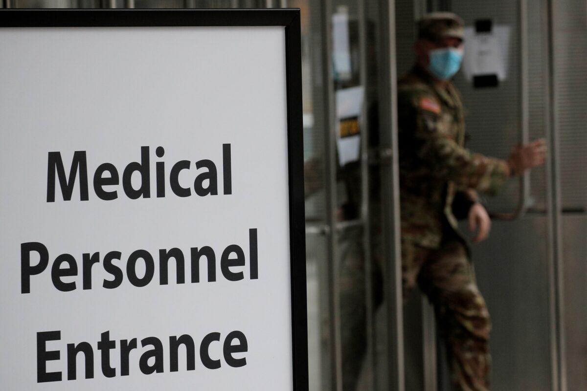 A U.S. military personnel wearing face mask walks outside the Jacob K. Javits Convention Center, which was converted into a hospital during the outbreak of the CCP virus, in New York City on April 27, 2020. (Brendan McDermid/Reuters)