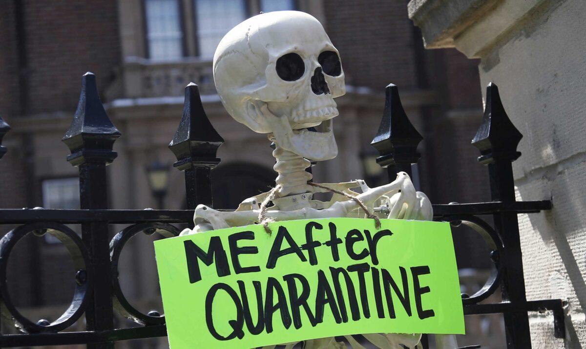 A mock skeleton is attached to the fence as protesters gathered outside Minnesota Gov. Tim Walz' official residence in St. Paul, Minn., on April 17, 2020, to call on him to loosen stay-at-home restrictions imposed across the state because of the coronavirus. (Jim Mone/AP Photo)