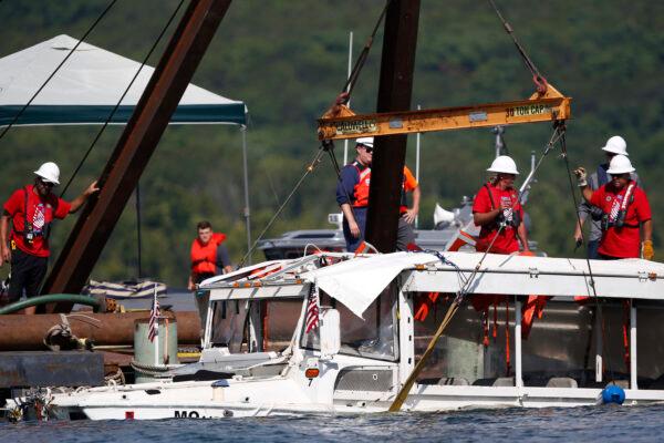A duck boat that sank in Table Rock Lake in Branson, Mo., is raised on July 23, 2018. It sank in the evening of July 19 after a thunderstorm generated near-hurricane strength winds. (Nathan Papes/The Springfield News-Leader/AP)